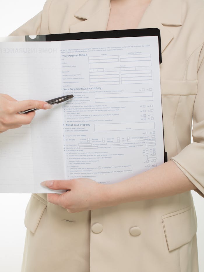Mastering the First Impression: Your intriguing post title goes here Close-up of a professional presenting insurance paperwork with a pen.